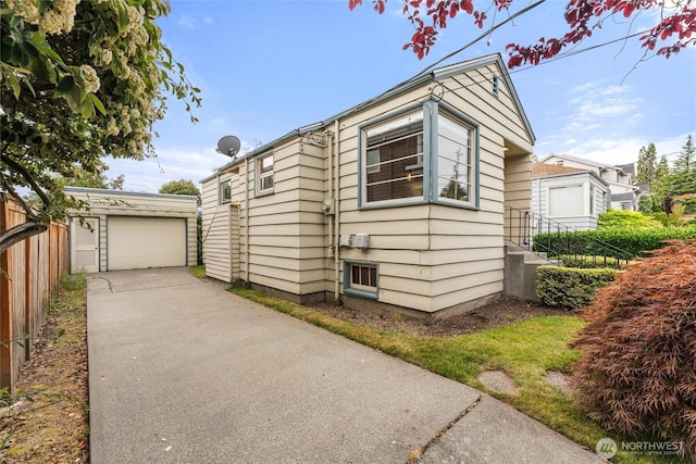 1327 N 79th St, Seattle, WA 98103 - view of side of home featuring an outdoor structure, driveway, and a garage