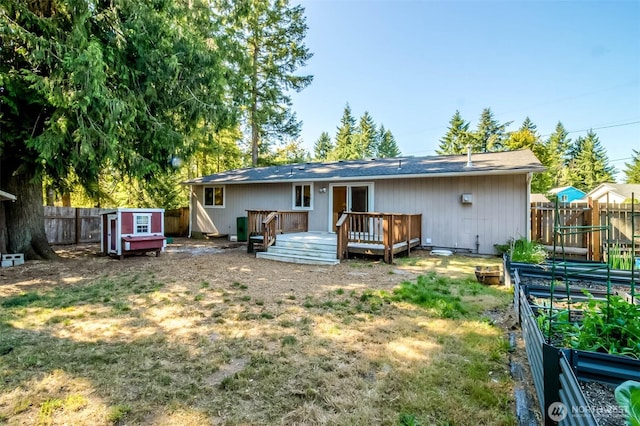 7601 Greenridge Loop SW, Olympia, WA 98512 - rear view of property featuring a vegetable garden and a wooden deck