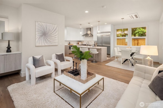 815 18th Ave W, Kirkland, WA 98033 - living room featuring wood finished floors, recessed lighting, and a chandelier