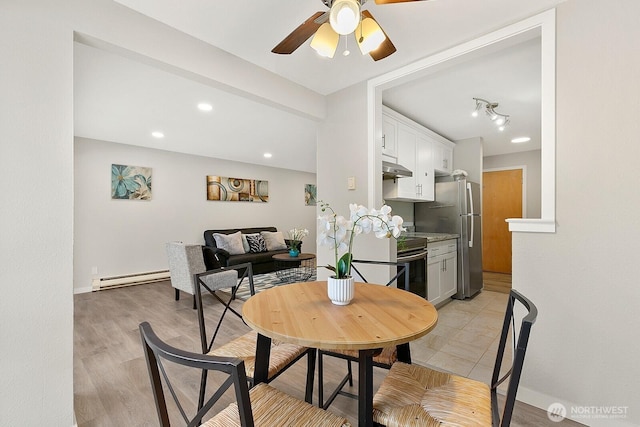 12700 NE 8th St Unit E-205, Bellevue, WA 98005 - dining room with baseboard heating, ceiling fan, recessed lighting, and light wood-type flooring