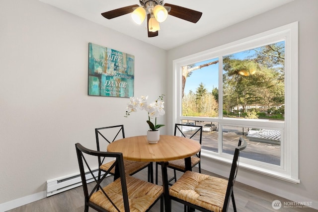 12700 NE 8th St Unit E-205, Bellevue, WA 98005 - dining area with wood finished floors, a baseboard radiator, and a ceiling fan