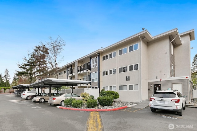 12700 NE 8th St Unit E-205, Bellevue, WA 98005 - view of building exterior with covered and uncovered parking
