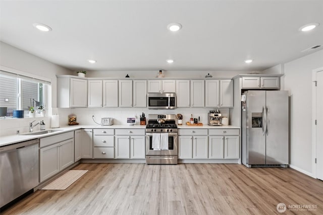 1423 Cascade St, Sultan, WA 98294 - kitchen with stainless steel appliances, tasteful backsplash, light countertops, light wood-type flooring, and recessed lighting