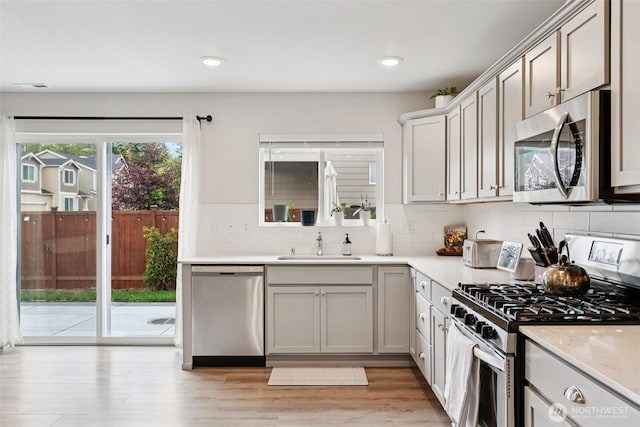 1423 Cascade St, Sultan, WA 98294 - kitchen with appliances with stainless steel finishes, tasteful backsplash, light countertops, recessed lighting, and light wood-style flooring