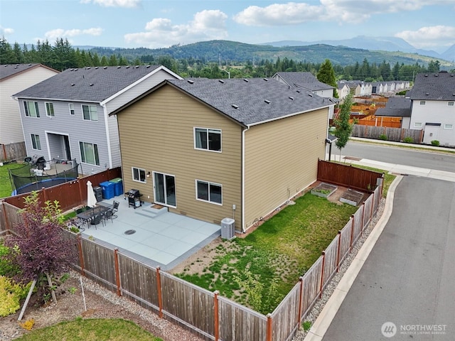 1423 Cascade St, Sultan, WA 98294 - rear view of property featuring a mountain view, a patio area, a fenced backyard, and a residential view
