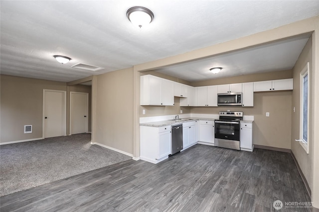 1514 Mt Brynion Rd, Kelso, WA 98626 - kitchen featuring stainless steel appliances, dark wood finished floors, light countertops, white cabinetry, and open floor plan