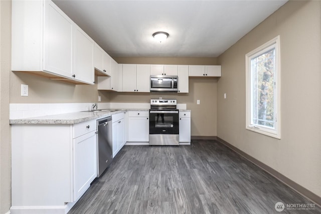 1514 Mt Brynion Rd, Kelso, WA 98626 - kitchen featuring stainless steel appliances, dark wood finished floors, white cabinets, and light countertops
