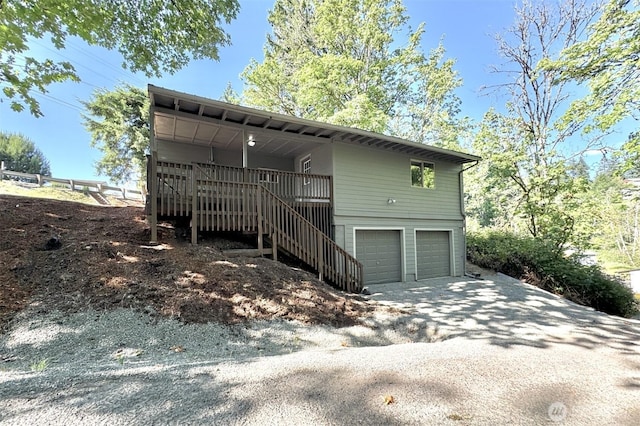 1514 Mt Brynion Rd, Kelso, WA 98626 - view of side of home with an attached garage, stairs, and driveway