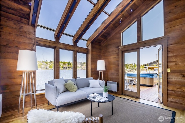 3123 Fairview Ave E Unit 2, Seattle, WA 98102 - living area with high vaulted ceiling, hardwood / wood-style flooring, beamed ceiling, wood walls, and a water view