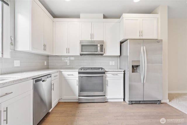 4239 NE 3rd Ln, Renton, WA 98059 - kitchen featuring appliances with stainless steel finishes, white cabinets, and tasteful backsplash