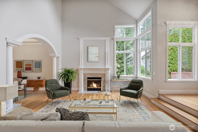 14691 NE 16th St, Bellevue, WA 98007 - living area featuring high vaulted ceiling, ornate columns, healthy amount of natural light, arched walkways, and wood finished floors
