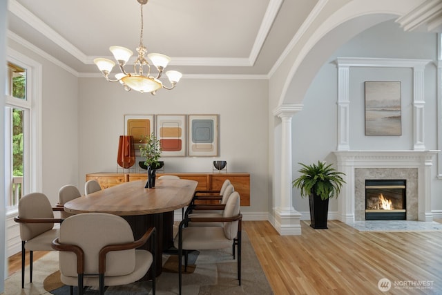 14691 NE 16th St, Bellevue, WA 98007 - dining room with light wood finished floors, arched walkways, a tray ceiling, a chandelier, and a high end fireplace