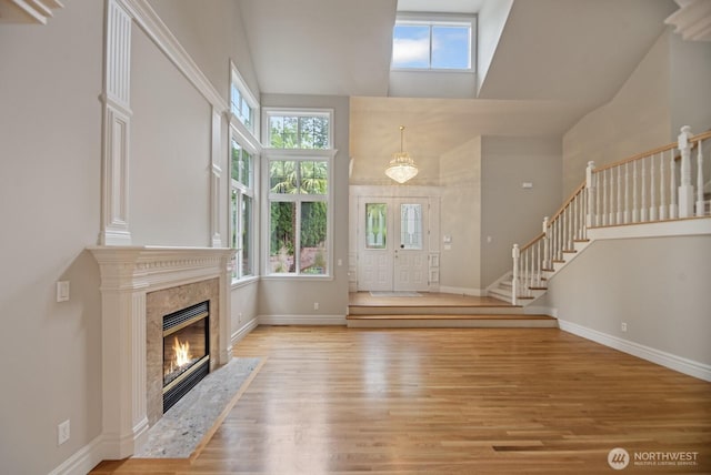 14691 NE 16th St, Bellevue, WA 98007 - foyer entrance featuring a towering ceiling, healthy amount of natural light, light wood finished floors, stairs, and a fireplace