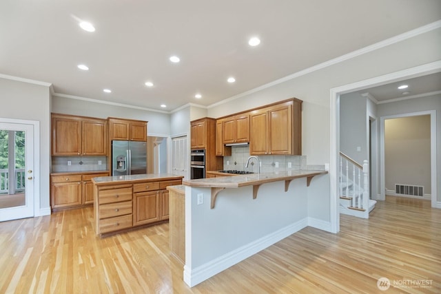 14691 NE 16th St, Bellevue, WA 98007 - kitchen with appliances with stainless steel finishes, light countertops, a peninsula, decorative backsplash, and recessed lighting