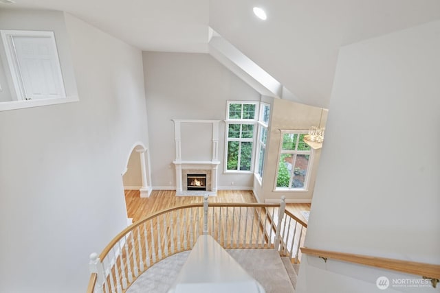 14691 NE 16th St, Bellevue, WA 98007 - stairway with wood finished floors, a fireplace with flush hearth, lofted ceiling, and recessed lighting