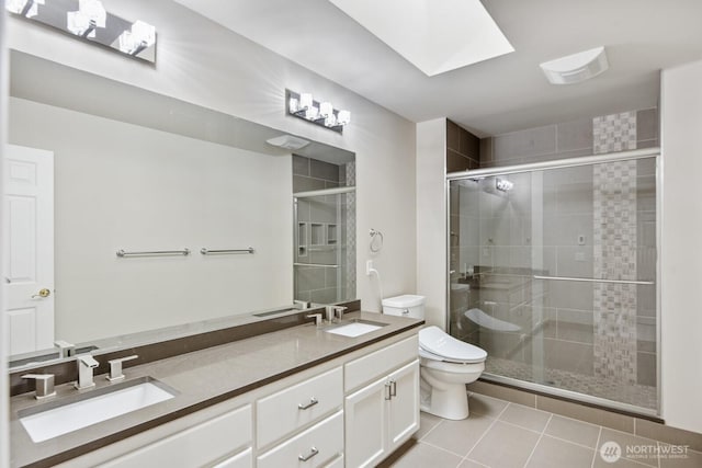 14691 NE 16th St, Bellevue, WA 98007 - bathroom featuring double vanity, tile patterned flooring, a shower stall, and a skylight