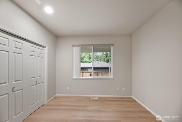 14691 NE 16th St, Bellevue, WA 98007 - unfurnished bedroom featuring light wood-style floors and a closet