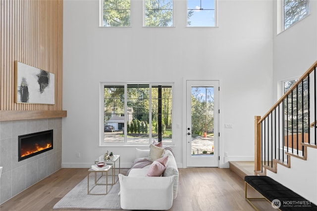 10520 NE 111th Pl, Kirkland, WA 98033 - living area with a towering ceiling, wood finished floors, stairs, and plenty of natural light