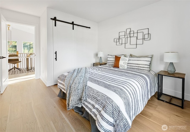10520 NE 111th Pl, Kirkland, WA 98033 - bedroom featuring a barn door and wood finished floors