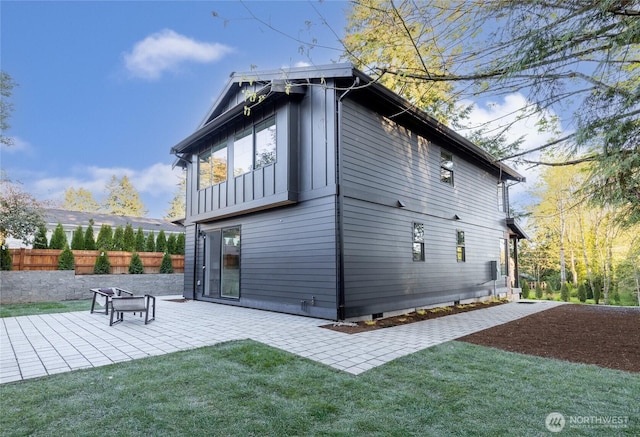 10520 NE 111th Pl, Kirkland, WA 98033 - rear view of house with a patio and board and batten siding