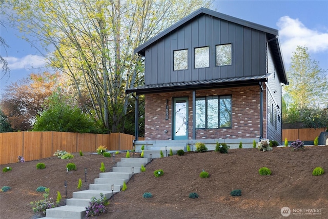 10520 NE 111th Pl, Kirkland, WA 98033 - view of front of home with brick siding, stairway, board and batten siding, covered porch, and a standing seam roof