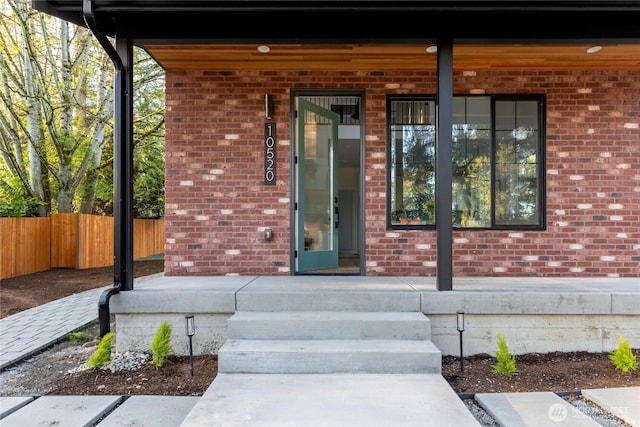 10520 NE 111th Pl, Kirkland, WA 98033 - doorway to property featuring covered porch and brick siding