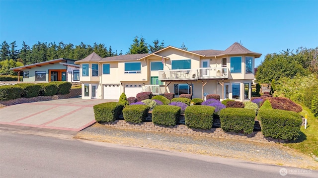 1223 Rainier Ln, Oak Harbor, WA 98277 - view of front of property with stucco siding, an attached garage, driveway, and a balcony