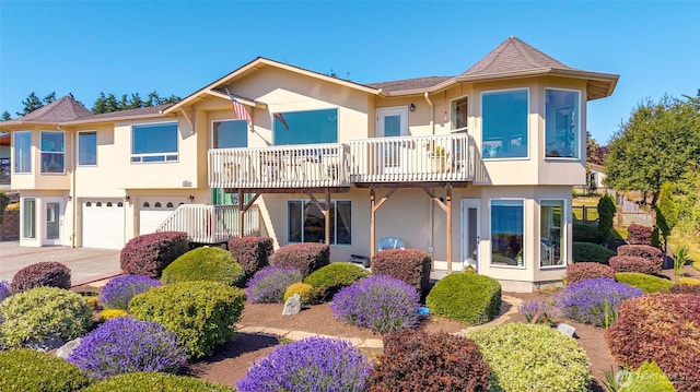 1223 Rainier Ln, Oak Harbor, WA 98277 - view of front of property with stucco siding, an attached garage, driveway, and a balcony