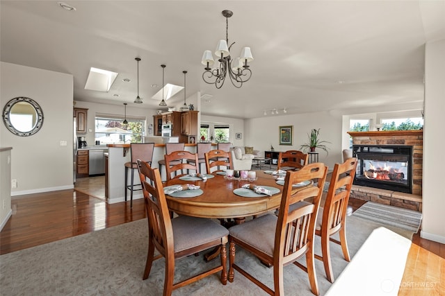 1223 Rainier Ln, Oak Harbor, WA 98277 - dining space featuring wood finished floors, a fireplace, and a chandelier