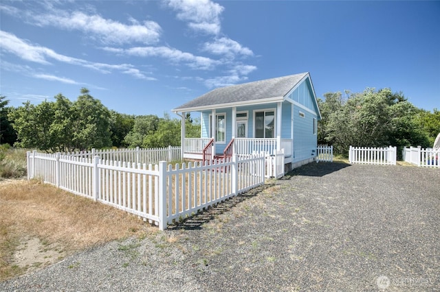 440 Marine View Dr SW Unit 3, Ocean Shores, WA 98569 - bungalow-style house with a porch, a fenced front yard, and roof with shingles