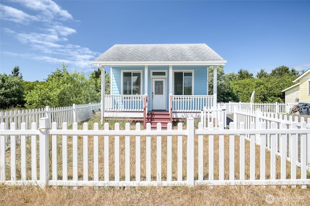 440 Marine View Dr SW Unit 3, Ocean Shores, WA 98569 - bungalow featuring covered porch, a shingled roof, and a fenced front yard