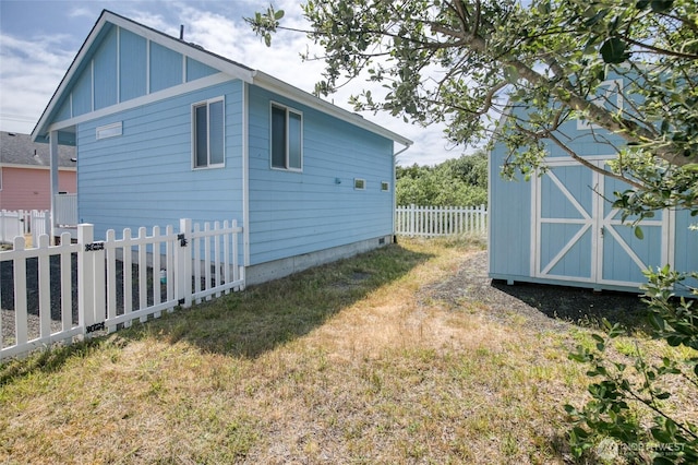 440 Marine View Dr SW Unit 3, Ocean Shores, WA 98569 - view of home's exterior featuring a fenced backyard and a shed