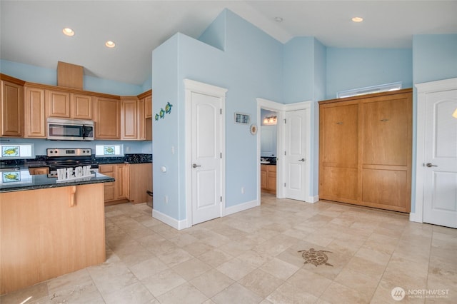 440 Marine View Dr SW Unit 3, Ocean Shores, WA 98569 - kitchen featuring stainless steel appliances, high vaulted ceiling, dark stone counters, a breakfast bar, and recessed lighting