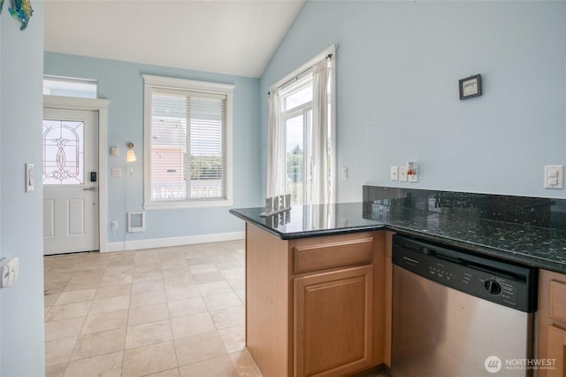 440 Marine View Dr SW Unit 3, Ocean Shores, WA 98569 - kitchen featuring dishwasher, lofted ceiling, dark stone counters, a peninsula, and light tile patterned flooring