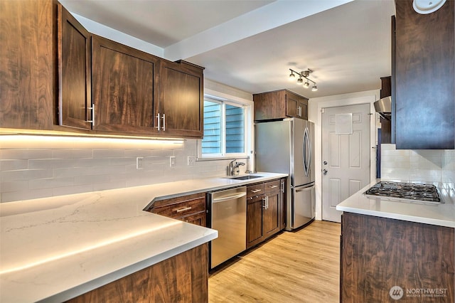 14305 109th Ave NE, Kirkland, WA 98034 - kitchen with appliances with stainless steel finishes, decorative backsplash, light wood-type flooring, dark brown cabinets, and light countertops