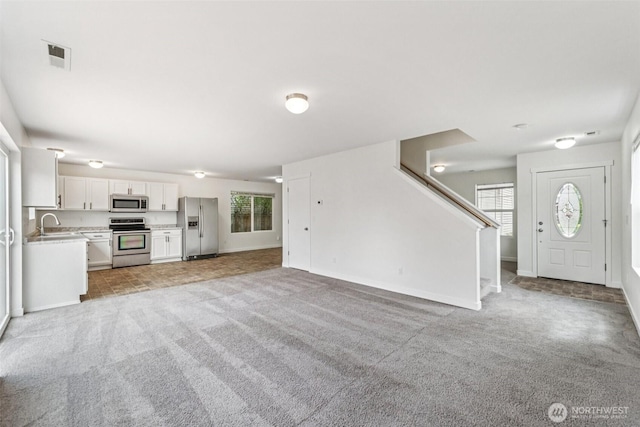 29775 218th Pl SE, Kent, WA 98042 - unfurnished living room with light carpet and stairway