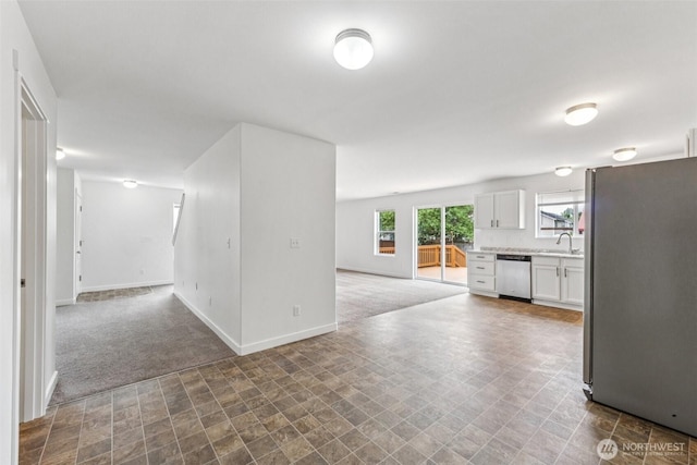 29775 218th Pl SE, Kent, WA 98042 - kitchen with stainless steel appliances, open floor plan, carpet floors, and white cabinetry