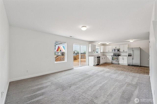 29775 218th Pl SE, Kent, WA 98042 - unfurnished living room featuring light colored carpet and baseboards