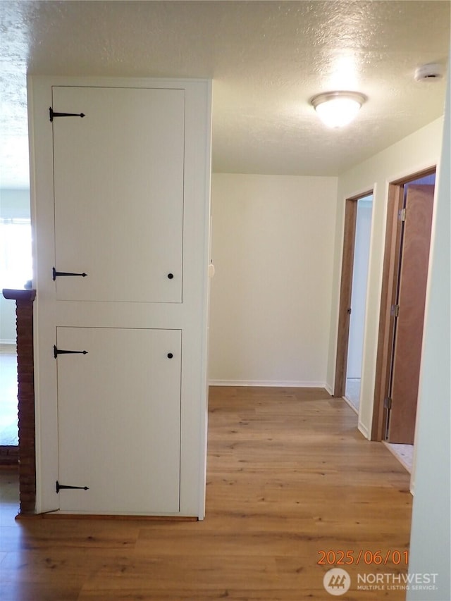 502504 4th St, Hoquiam, WA 98550 - hall with light wood finished floors and a textured ceiling