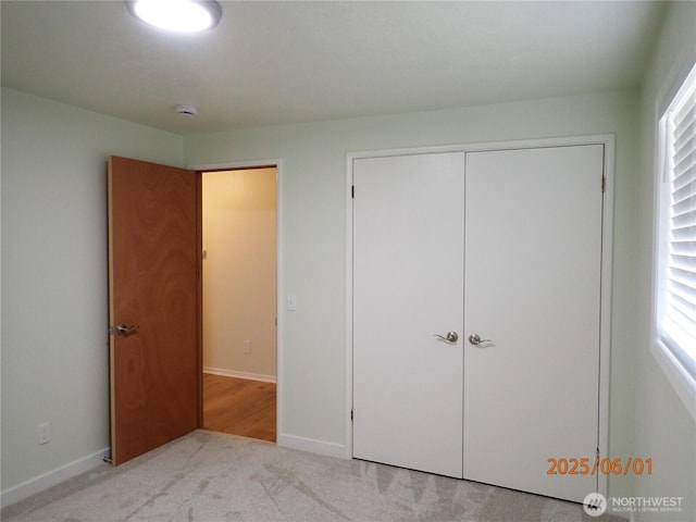 502504 4th St, Hoquiam, WA 98550 - unfurnished bedroom featuring a closet, carpet flooring, and multiple windows