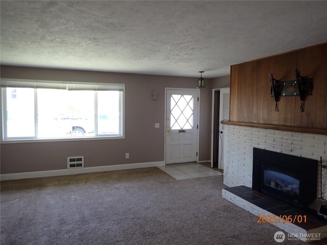 502504 4th St, Hoquiam, WA 98550 - unfurnished living room with a textured ceiling, light colored carpet, and a fireplace