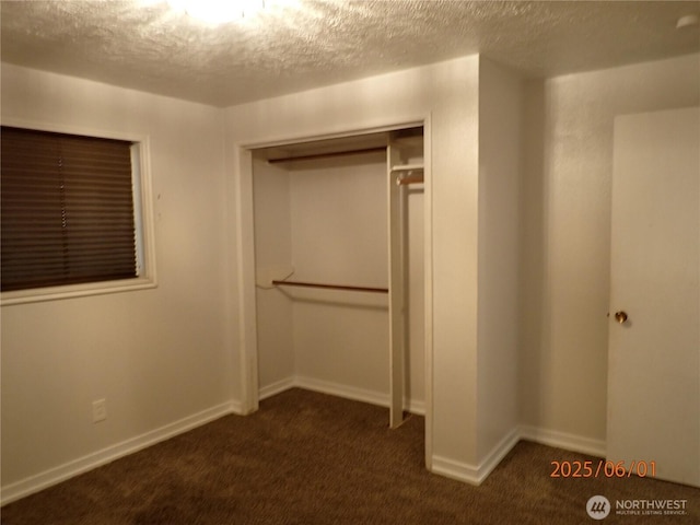 502504 4th St, Hoquiam, WA 98550 - unfurnished bedroom with dark carpet, a textured ceiling, and a closet