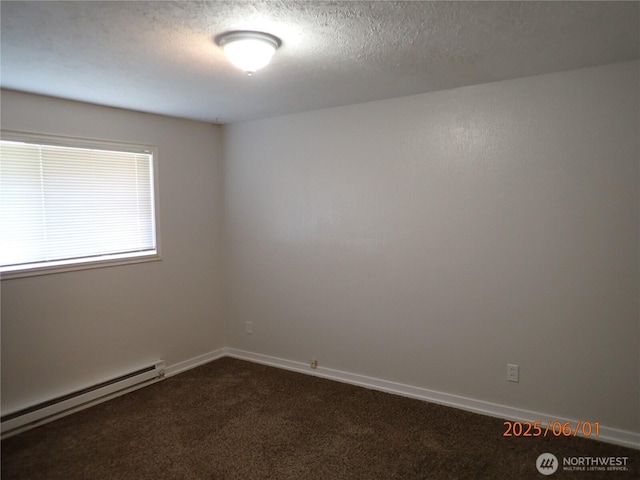 502504 4th St, Hoquiam, WA 98550 - empty room featuring baseboard heating, dark colored carpet, and a textured ceiling