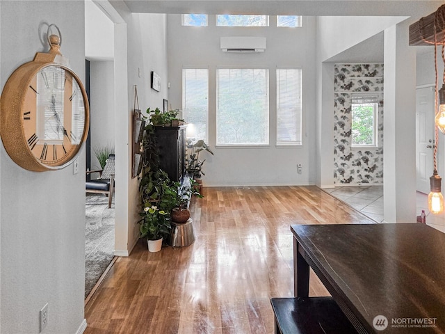 503 S 47th St Unit 11F, Renton, WA 98055 - foyer with wood finished floors and a wall unit AC