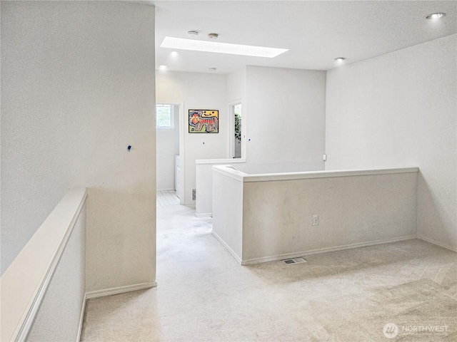 503 S 47th St Unit 11F, Renton, WA 98055 - hallway with a skylight, light carpet, recessed lighting, and an upstairs landing