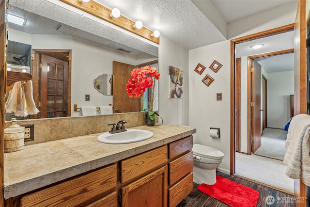 4115 Sunset Way, Longview, WA 98632 - bathroom with vanity, wood finished floors, and a textured ceiling