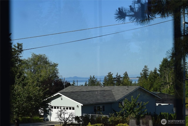990 Madrona Way, Sequim, WA 98382 - view of front of home with a garage, a mountain view, a shingled roof, and driveway