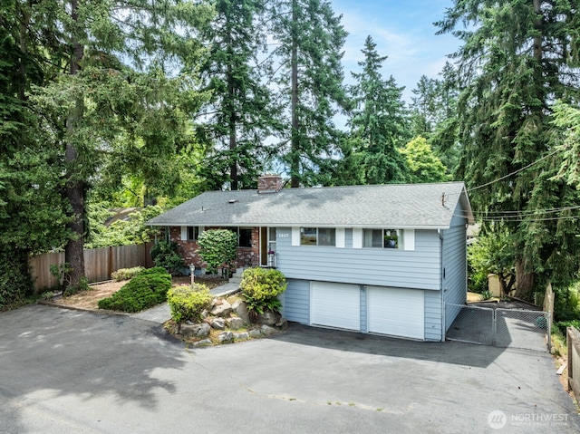 1847 N 183rd St, Shoreline, WA 98133 - view of front of home featuring driveway, a chimney, an attached garage, and a shingled roof
