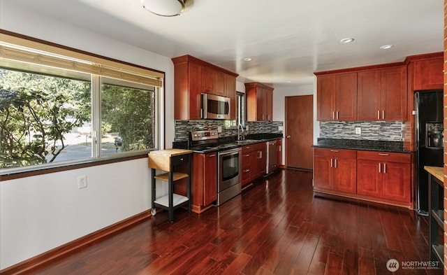 1847 N 183rd St, Shoreline, WA 98133 - kitchen with appliances with stainless steel finishes, reddish brown cabinets, dark wood-type flooring, decorative backsplash, and recessed lighting