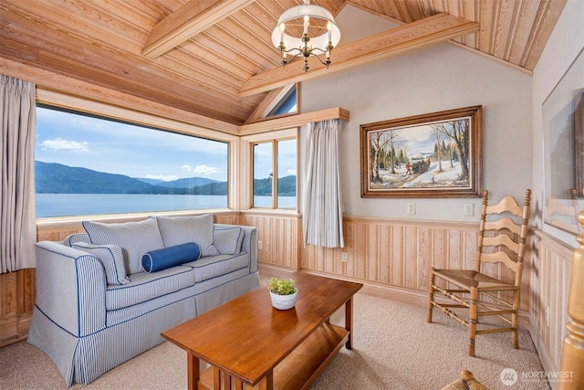 2247 Northshore Rd, Bellingham, WA 98226 - carpeted living room featuring wooden ceiling, a wainscoted wall, a water and mountain view, a chandelier, and wooden walls